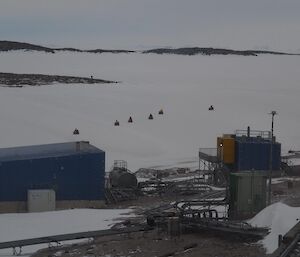 A group of people on quads depart station