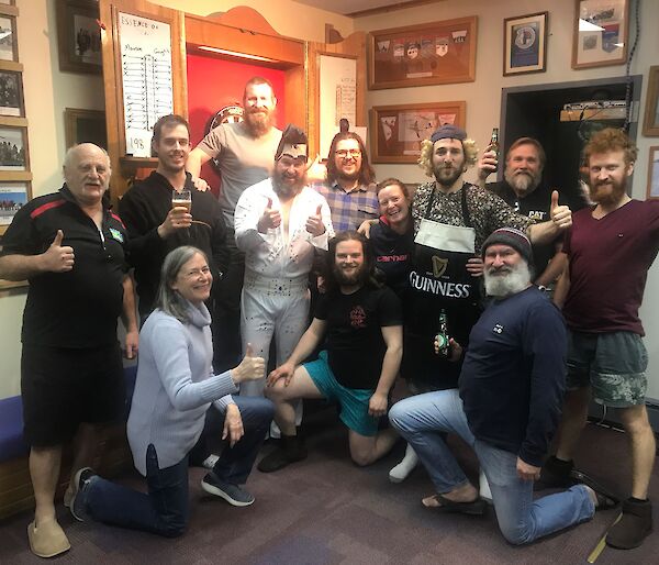 A group of people with their winning dart board