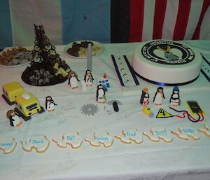 A dessert table with icing penguins