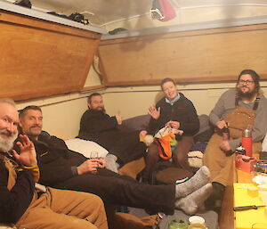 A group of people inside a field hut