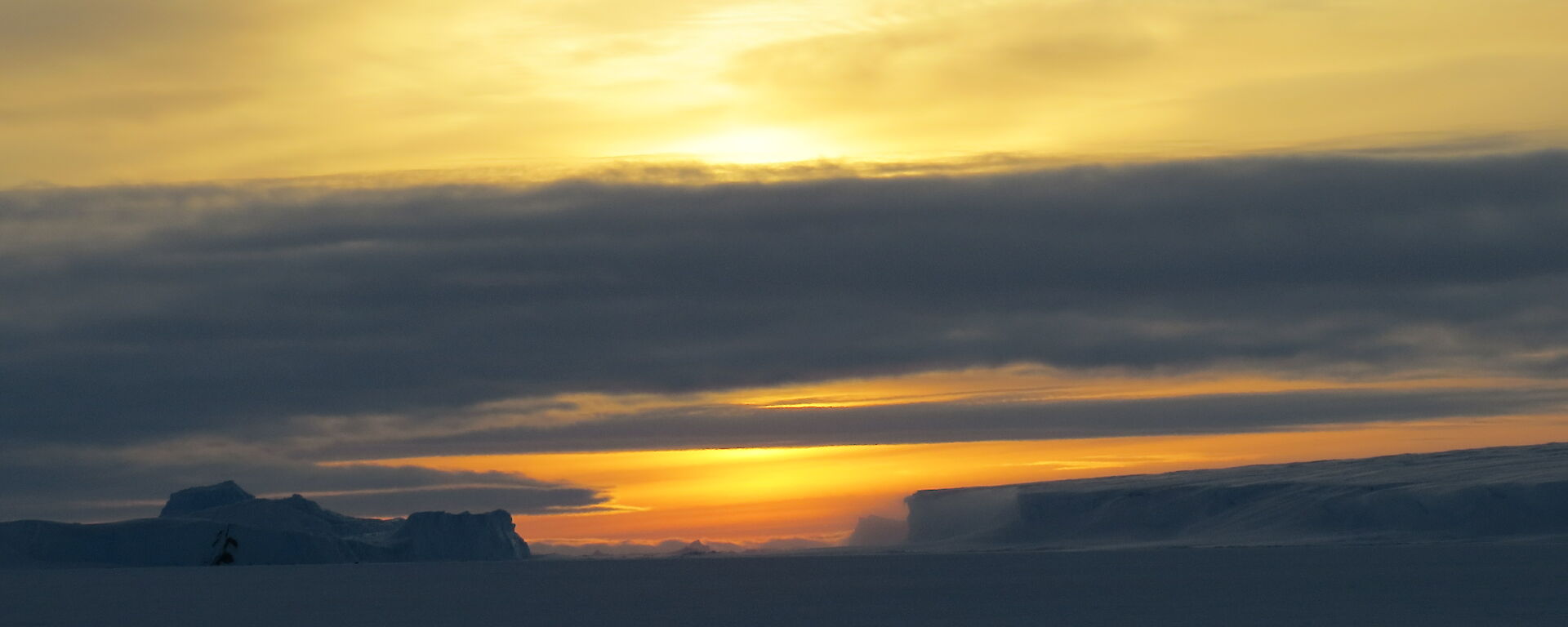 A sunrise sky with icebergs