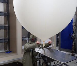 A man prepping a weather balloon