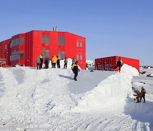 A group of people working on the blizz tail by the Red Shed