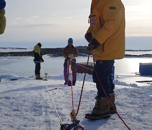 A hauling system loaded with a person on harness ready to go over the edge.