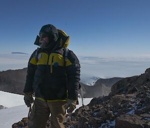 A man stands on the route up Mt Henderson