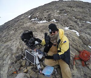 A men services one of the penguin monitoring cameras