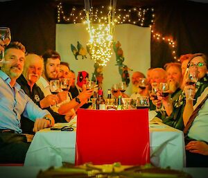 A group of people toasting at a table