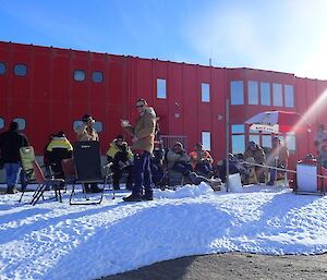 A group of people BBQ on the blizz tail outside the Red Shed