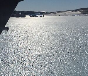 A group of people on the ice waiting for a plane