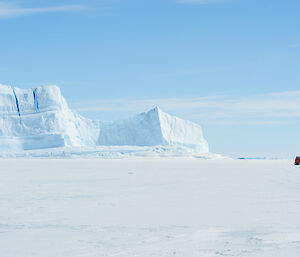 Orange Hagg passes an iceberg on the sea ice