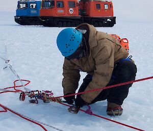 A man checks a rope rescue system