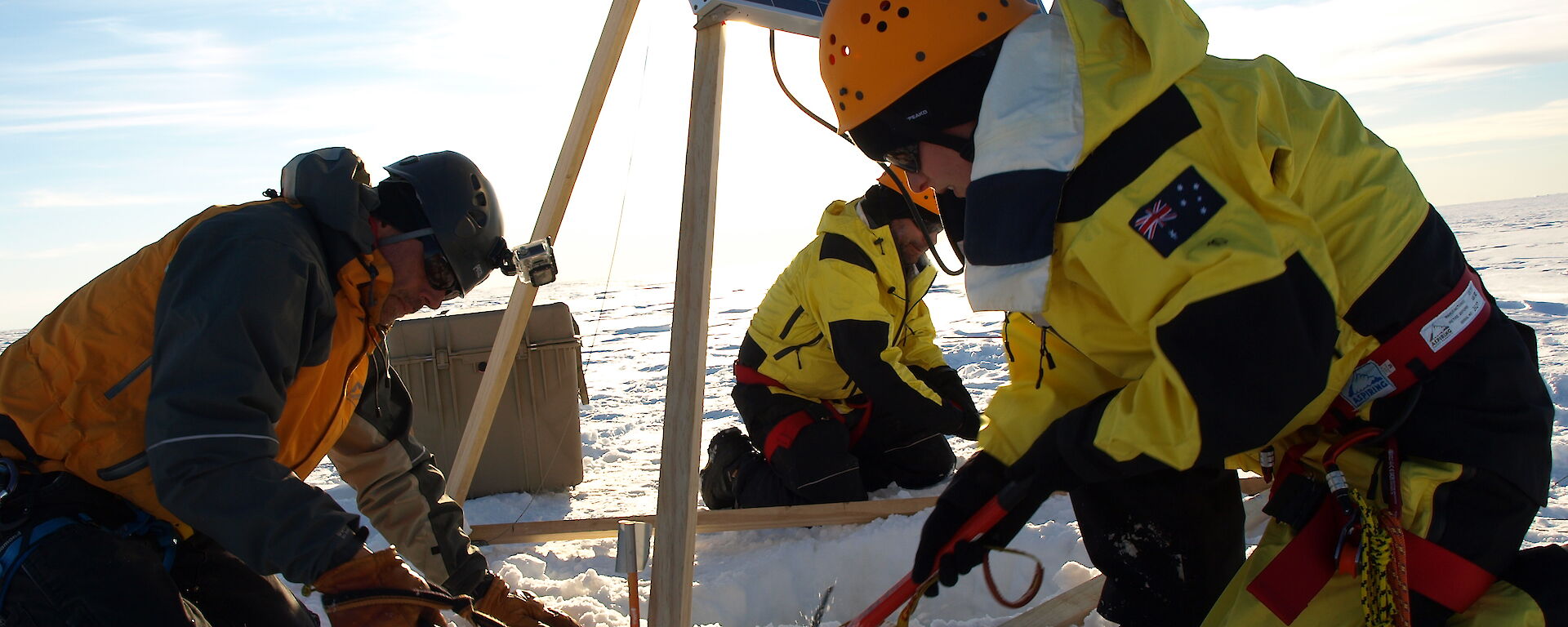 Dr Sue Cook (right) and two helpers install the GPS and solar panels on the Sørsdal Glacier in 2015–16.