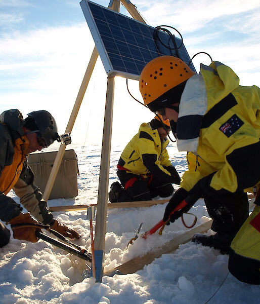 Dr Sue Cook (right) and two helpers install the GPS and solar panels on the Sørsdal Glacier in 2015–16.