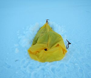 A small bivvy bag in the snow.