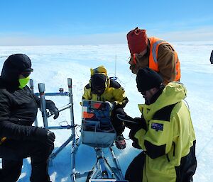 The project team wire a data logger on the ice.