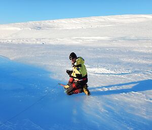 Christian Schoof deploys a pressure transducer at the Channel Lake site.