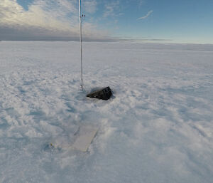 A black box containing a radar unit, floating in icy meltwater on the Sørsdal Glacier.