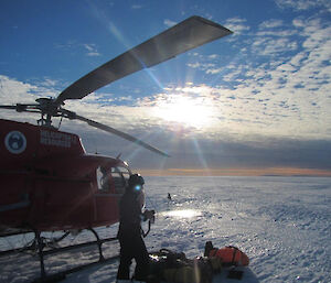 Unloading the helicopter during a spectacular evening on the Sørsdal Glacier.