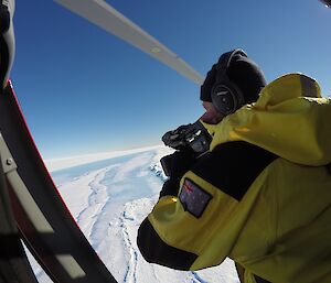 ABC cameraman Peter Curtis films the Horseshoe Lake site from the air.