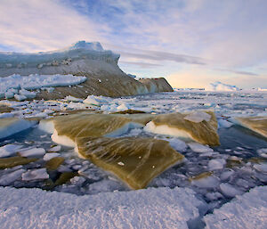 Overturned ice floes with green sea ice algae on their undersides.