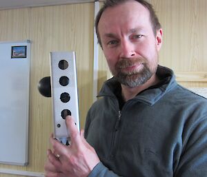 Marine biogeochemist Rob Strzepek, points out the conductivity sensor behind its protective shield.