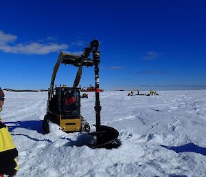 The fast-ice team drill a hole for the Remotely Operated Vehicle (ROV).