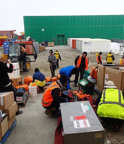 The fast-ice team unload their science gear container at Davis station.