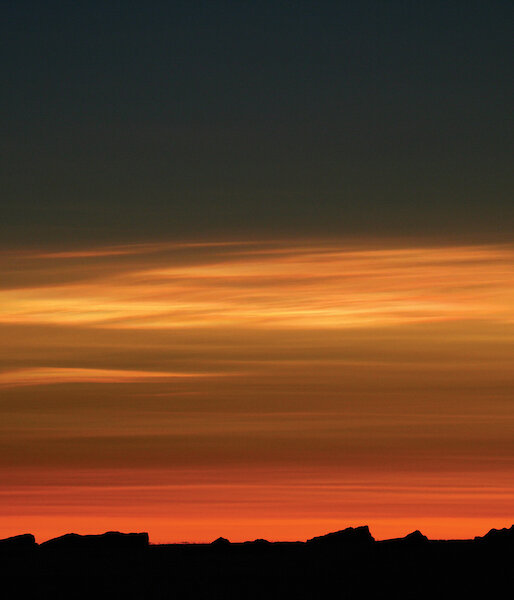 Stratospheric clouds, seen here illuminated by the sun during twilight.