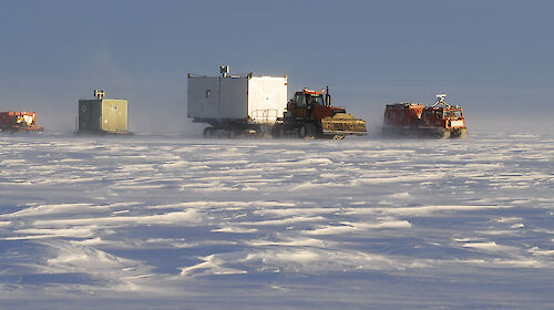 A traverse train of four vehicles at Law Dome in 2008.