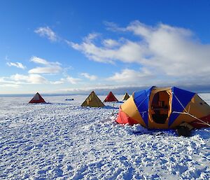 The field training camp site with the mess tent (foreground) and the four polar pyramid sleeping tents.