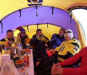 Six expeditioners in the mess tent.
