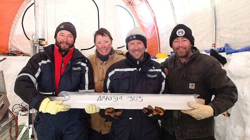 Four scientists hold the last piece of the main ice core
