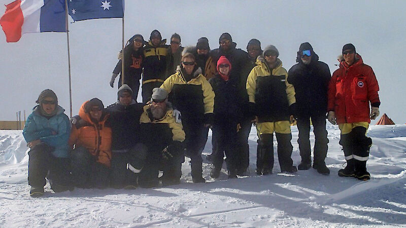 The second group of Aurora Basin team members pose at the camp site with the Australian and French flags flying.