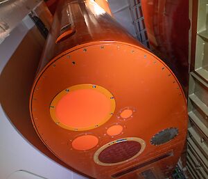 An orange keel suspended in a vertical shaft