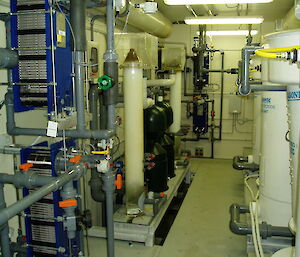 The many tanks and pipes of the aquarium filtration system.