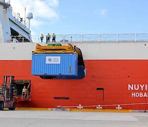 A blue shipping container containing wild Antarctic krill, being lifted off RSV Nuyina after an Antarctic voyage.
