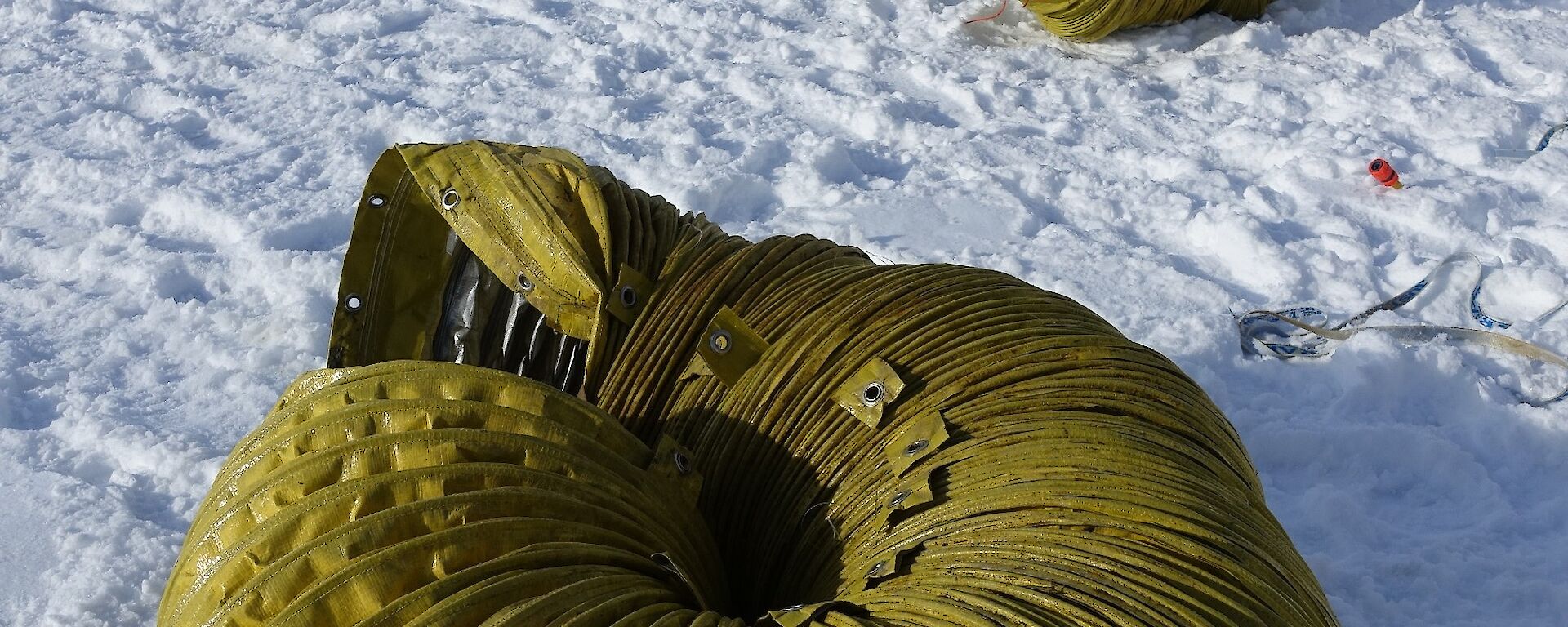 The yellow ducting dismantled into its original 10m long sections and tied up on the sea ice, ready to be transported back to station