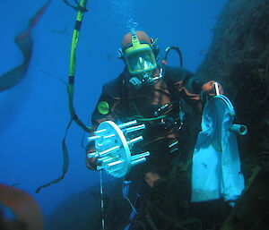 A diver collects samples under the ice