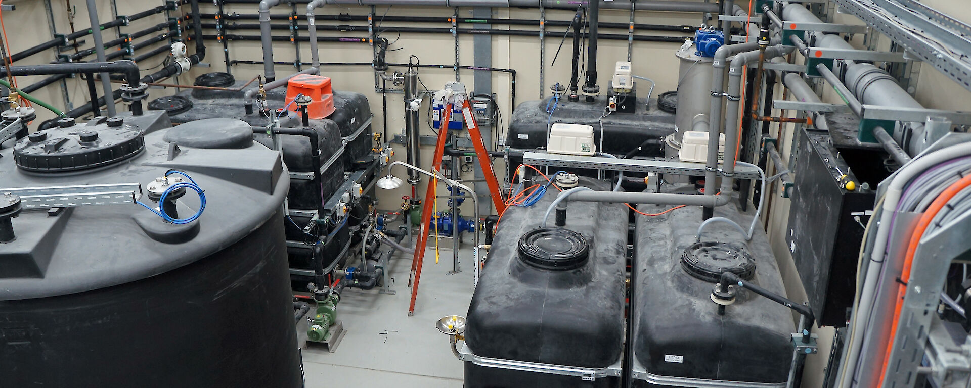 The secondary treatment plant newly installed at Davis research station in December 2015. This photo shows the inlet buffer tanks (front right) where wastewater from the station enters. An even, controlled flow is then directed through the various treatment processes. Once treated, sludge is directed into the sludge tank (front left) and treated water is collected in the effluent tanks (back left) before being pumped to the ocean outfall.