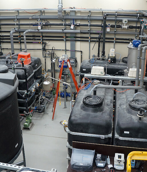 The secondary treatment plant newly installed at Davis research station in December 2015. This photo shows the inlet buffer tanks (front right) where wastewater from the station enters. An even, controlled flow is then directed through the various treatment processes. Once treated, sludge is directed into the sludge tank (front left) and treated water is collected in the effluent tanks (back left) before being pumped to the ocean outfall.