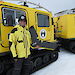 James Rennie with the fixed-wing Sensefly eBee drone, standing beside a Hagglund in Antarctica.