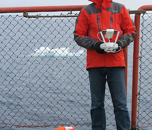 James Rennie and the quadcopter Inspire 1 during flights off the Aurora Australis helideck.