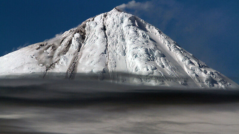 The Big Ben volcano on Heard Island with smoke drifting from its mouth.