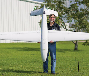 Scott Arndt, lead designer of Tiburon Junior, shows off “Junior”, with its 3m wingspan. The drone can carry a 9kg scientific payload that will allow ICECAP scientists to measure the elevation of the ice sheet.