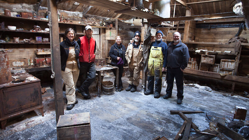 The Mawson’s Huts conservation team inside the Main Hut, on completion of the season’s work. L-R: Michelle Berry, Marty Passingham, Sally Hildred, Ian Godfrey, Peter Maxwell and David Killick.