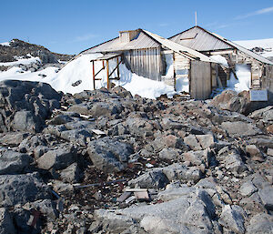 External view of Main Hut showing the entrance to the hut blocked with snow and ice.