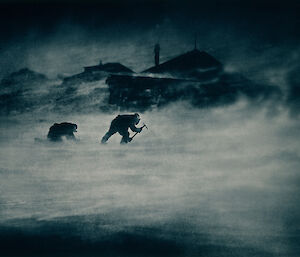 Frank Hurley’s iconic image of Leslie Whetter and John Close collecting ice in a blizzard.