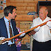 Australian Antarctic Division General Manager – Strategies, Mr Charlton Clark (left), hands over the original flagpole from Mawson’s Main Hut to Mr David Jenson to display in the Mawson’s Huts Replica Museum.