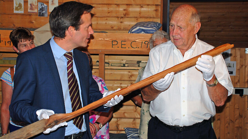 Australian Antarctic Division General Manager – Strategies, Mr Charlton Clark (left), hands over the original flagpole from Mawson’s Main Hut to Mr David Jenson to display in the Mawson’s Huts Replica Museum.