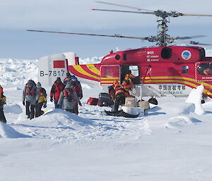 Passengers leave a Chinese helicopter on the sea ice.